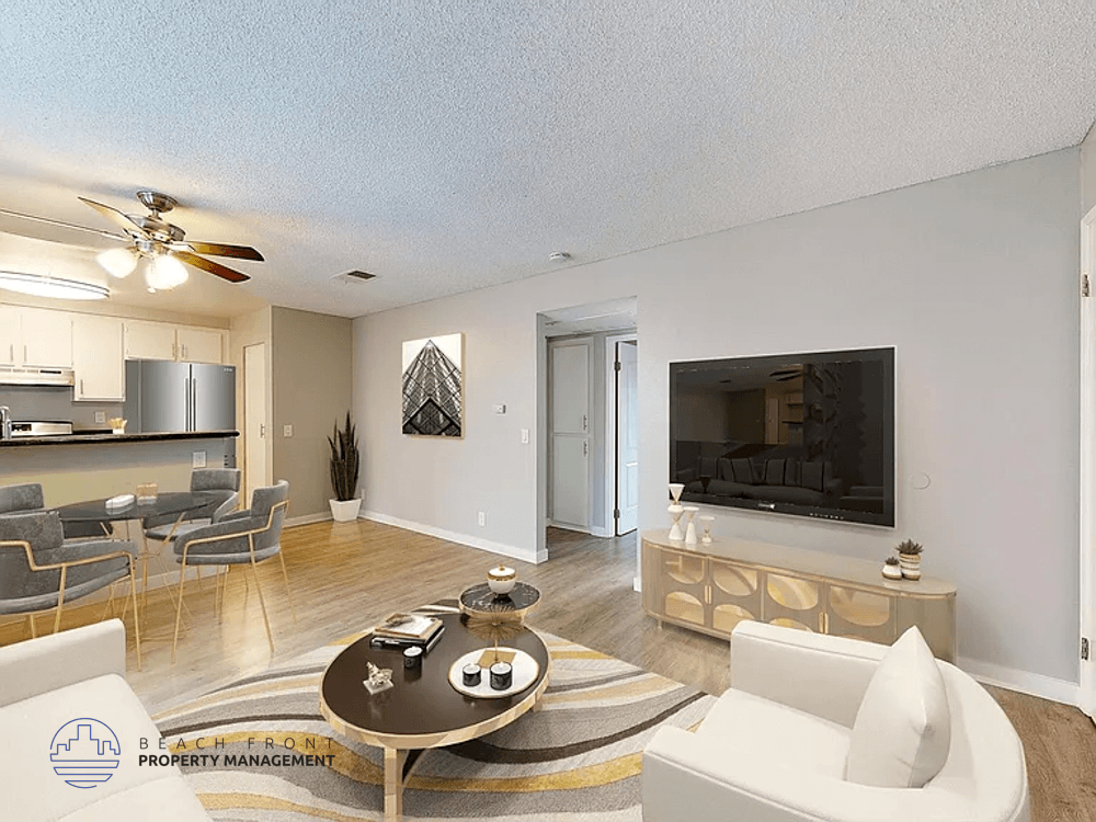 A living room with a television, a sofa, and a coffee table.